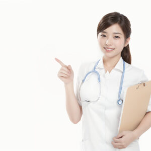 人差し指を指して案内する女性看護師